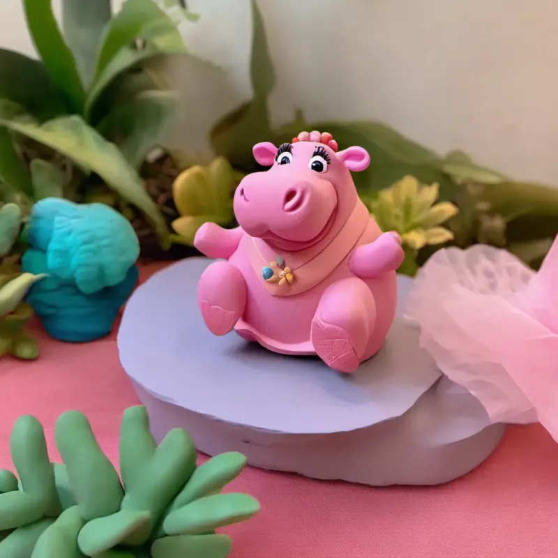 Hidie Hippo wakes up in her river home, feeling happy.